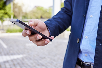 Image showing Cell phones are the latest invention in rudeness. an unrecognizable businessman using a smartphone outside.