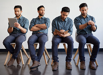 Image showing Manage your time, manage your life. a young businessman waiting in a line in a modern office.