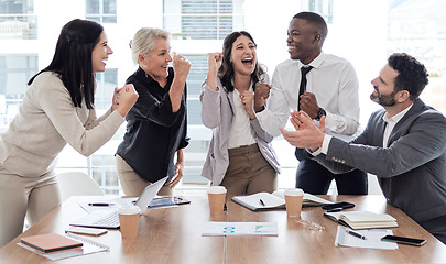Image showing Your win is our win too. a group of businesspeople cheering in a meeting at work.