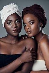 Image showing Our heritage is our identity. Studio portrait of two beautiful young women posing against a grey background.