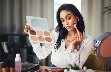 Image showing Ill show you how to get your glow on. a influencer recording a makeup tutorial for her blog at home.