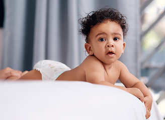 Image showing Life got a lot cuter when I came along. an adorable baby boy on the bed at home.