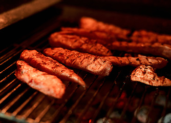 Image showing That smokey, grilled taste is the best. Closeup shot of meat being barbecued on a grill.