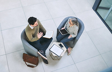 Image showing Coming up with solutions that best suit their business. High angle shot of two businesspeople having a discussion in an office.