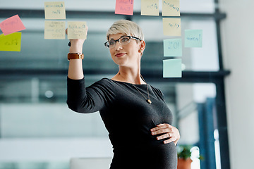 Image showing Aspire to be innovative and creative. a pregnant businesswoman brainstorming with notes on a glass wall in an office.