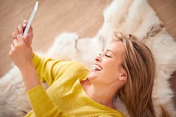 Image showing But first lets take a selfie. A yong woman smiling happily while taking a self portrait on her digital tablet.