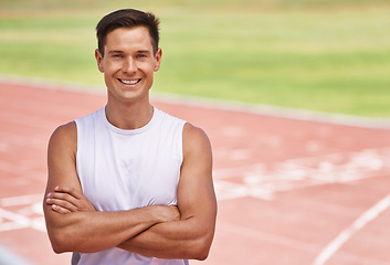 Image showing Just happy to be competing. Portrait of a happy handsome athlete standing on the track.