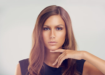 Image showing Always holding her head high. Portrait of a gorgeous young woman holding her finger below her chin.