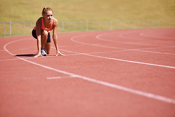 Image showing Ready for a race. an attractive young runner out on the track.