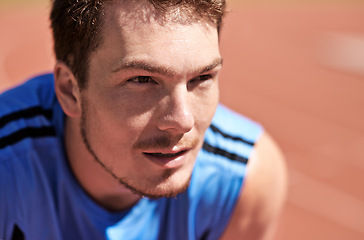 Image showing Hes ready to race. a handsome young runner out on the track.