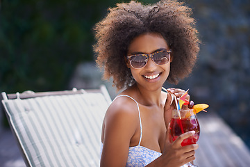 Image showing What holidays should be all about. Attractive ethnic female enjoying her fruity cocktail.