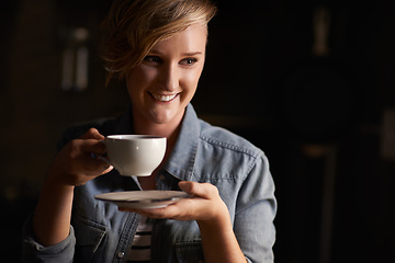 Image showing Everythings better with tea. an attractive young woman drinking tea in her kitchen.