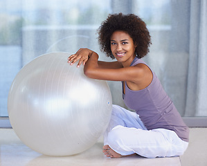 Image showing The all-round workout tool. Full-length portrait of an attractive young woman sitting with an exercise ball.