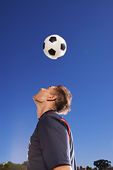 Image showing Getting his head in the game. a young footballer bouncing a ball on his head.