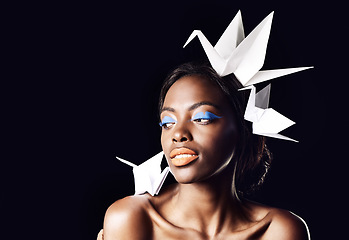 Image showing Whispers of a quiet conversation. a beautiful ethnic woman posing with origami birds on her head and shoulders.