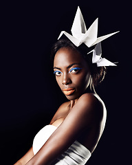 Image showing Beauty radiating no matter the circumstance. Portrait of a beautiful ethnic woman posing with origami birds on her head.