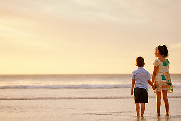 Image showing Dont let go of my hand. an adorable brother and sister bonding at the beach.