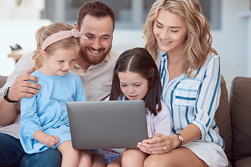 Image showing Happy young caucasian family sitting on a sofa at home and using a laptop to browse the internet. Adorable little girls bonding with mother and father while watching a movie. Family enjoying a show