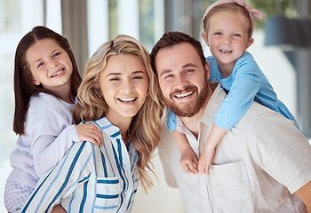 Image showing Happy caucasian family of four smiling while relaxing together at home. Carefree loving parents bonding with their cute little daughters. Sisters playing with their parents on the weekend