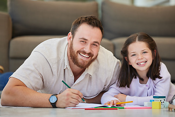 Image showing Father and daughter doing homework together drawing pictures and having fun. Dad teaching daughter while using book and colouring pencils