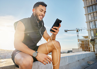 Image showing I created this playlist especially for working out. a man wearing earphones while sitting outside in exercise clothes.