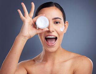 Image showing Your skin needs a good moisturiser. Studio shot of a beautiful woman holding up a skincare product.
