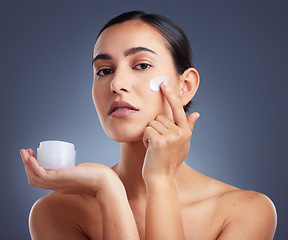 Image showing This stuff really work like magic. Studio shot of a beautiful woman using a skincare product.