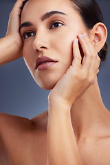 Image showing Its all in the skin. Studio shot of a beautiful young woman posing against a grey background.