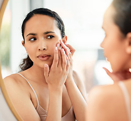 Image showing Cant have any pimples. a young woman popping a pimple on her face in the bathroom at home.