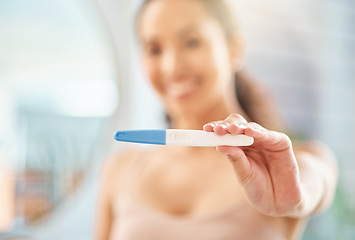 Image showing Weve got a result. an unrecognizable woman holding a pregnancy test at home.