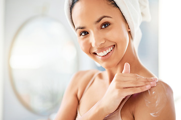 Image showing When my skins happy, Im happy. a young woman applying cream at home.