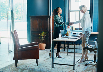 Image showing Thanks for coming in. Full length shot of two attractive and diverse businesswomen shaking hands during a meeting in an office.