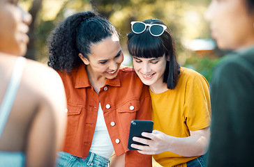 Image showing Life is partly what we make it. two friends using a phone in a park.