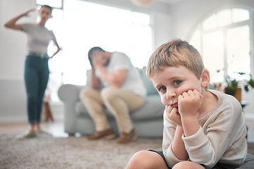 Image showing A persons a person, no matter how small. a little boy looking sad while his parent argue at home.