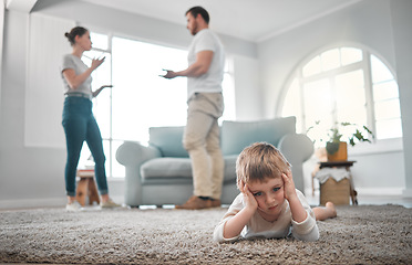 Image showing Children are taught how to think, not what to think. a little boy looking sad while his parent argue at home.