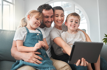 Image showing Shake our family tree and youll get some nuts. a young family using a digital tablet at home.