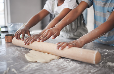 Image showing Teach them while theyre young. two unrecognizable children having fun while baking in the kitchen at home.