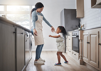 Image showing I think my mom is amazing. a little girl and her mother dancing in the kitchen at home.