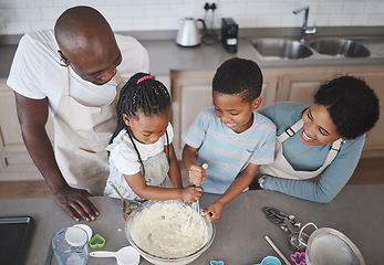 Image showing The measuring and mixing always smoothed out her thinking processes. a family baking together in the kitchen.