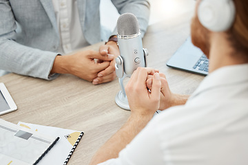 Image showing Stay tuned as we uncover the latest news. Closeup shot of two businessmen using a microphone during a broadcast in an office.