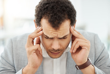 Image showing My brain is in overdrive. a young businessman looking stressed out in an office.