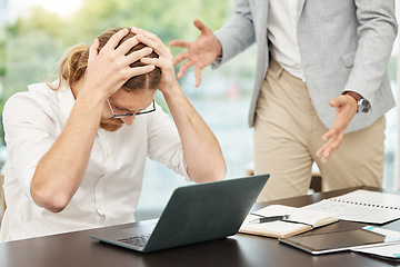 Image showing Im drowning under all these demands. a young businessman looking stressed out during an argument with a colleague in an office.