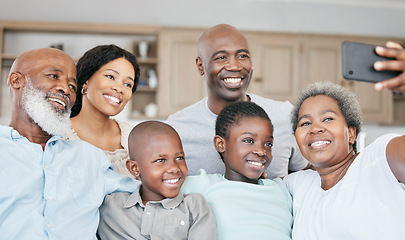 Image showing Pass along the value of empathy to our children. Portrait of a family with their grandparents taking a selfie together at home.