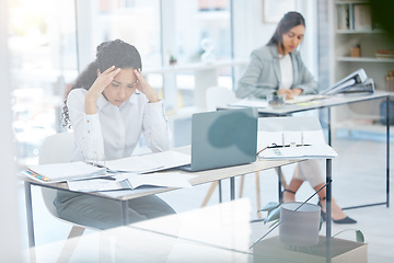 Image showing Feeling overwhelmed. a young businesswoman looking overwhelmed in an office at work.