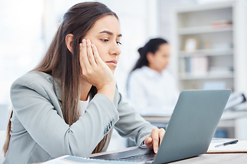 Image showing Ive got nothing to do today. a young businesswoman looking bored while using a laptop in an office at work.