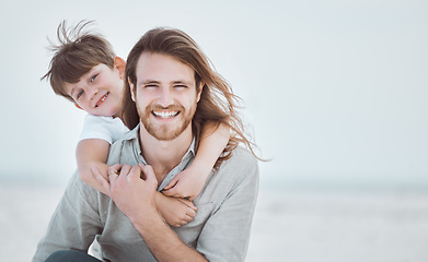 Image showing Hes got a supporter for life in me. a young father and son spending time together at the beach.