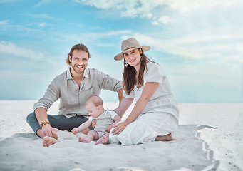 Image showing Babys first day at the beach. a young family spending a day at the beach.