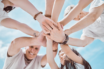 Image showing My family is the best team. Low angle shot of a family stacking their hands at the beach.