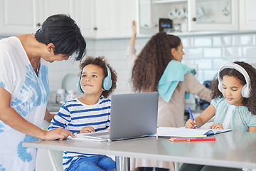 Image showing No time for cuddles, sorry gran. a mature woman helping her grandkids with their school work at the kitchen table.