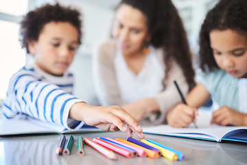 Image showing I need more blue. a mother helping her kids with homework at the kitchen table.